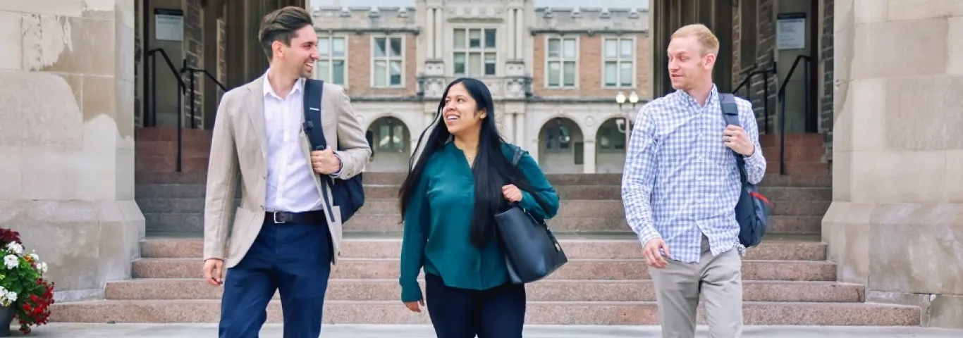 "Grad students walking in front of Brookings Hall arch"