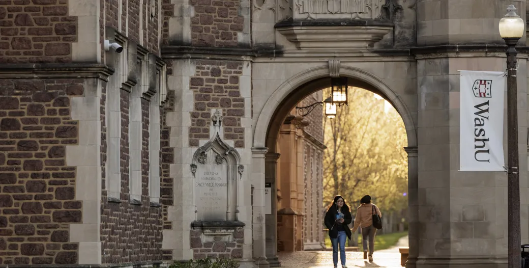 "Student walking through an archway on Danforth Campus"