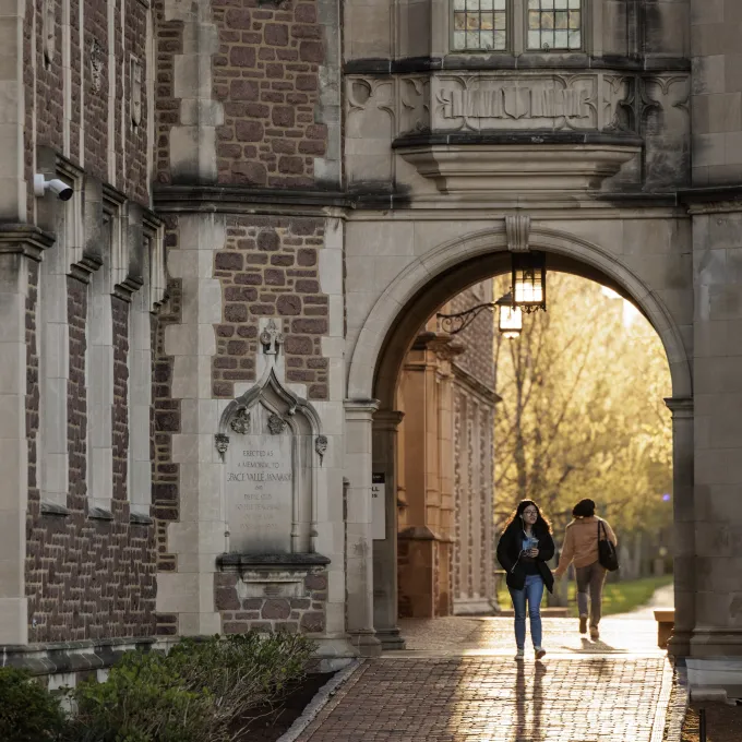 "Student walking through an archway on Danforth Campus"