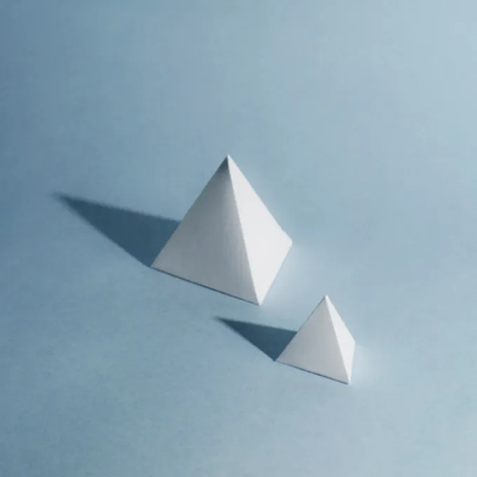 Two white pyramids of differing sizes